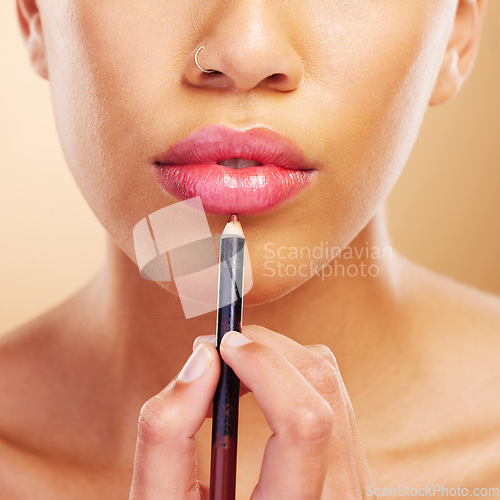 Image of Mouth, woman or closeup of lip pencil for makeup, facial skincare or beauty cosmetics in studio. Hand, model or person with lipstick product to outline lips, aesthetic makeover and color application