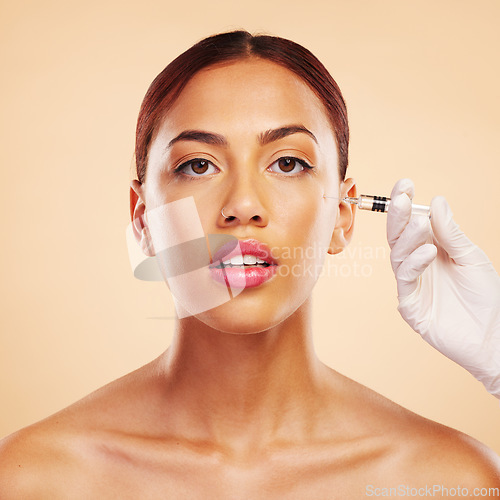 Image of Portrait, woman or plastic surgery with facelift injection or cosmetics isolated on studio background. Hand, cheek or Brazilian model with needle, dermatology or beauty in facial medical procedure