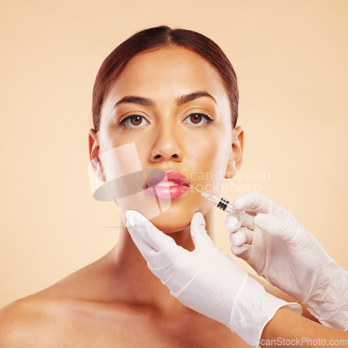 Image of Portrait, woman or plastic surgery with a needle, lip filler and cosmetics isolated on studio background. Hands, lips or face of model with injection, dermatology and beauty with medical procedure