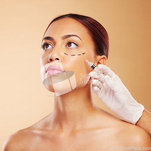 Image of Ophthalmic, plastic surgery and face of woman with beauty facial for isolated in brown studio background. Skincare, cosmetics and young person with syringe for treatment or medical transformation