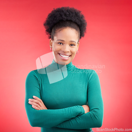 Image of Happy, portrait and a black woman in studio with arms crossed, confidence and a positive mindset. Fashion, smile and african female model person in casual clothes on a red background for motivation