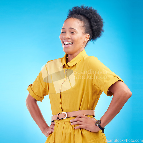Image of Happy, laughing and a black woman in studio with funny humor, confidence and a positive mindset. Fashion, hands in hips and african female model person in casual clothes on a blue background