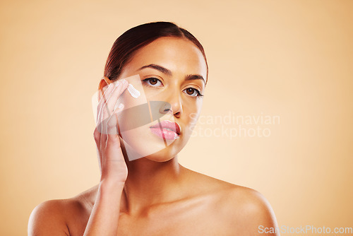 Image of Skincare, portrait or woman with face cream or sunscreen product in grooming routine with cosmetics. Dermatology, studio background or beauty model applying natural facial creme lotion moisturizer