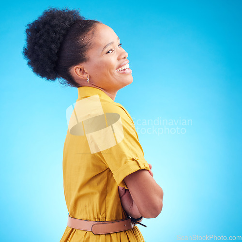 Image of Happy, laughing and a black woman in studio with funny humor, confidence and a positive mindset. Fashion, arms crossed and profile of a female model person in casual clothes on a blue background