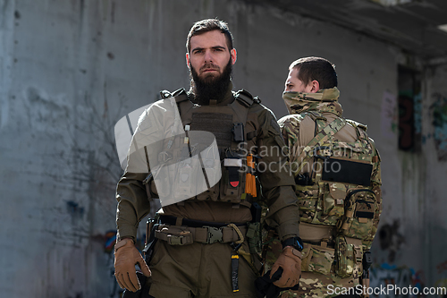 Image of Modern warfare soldiers in dark with combat ammunition and weapons in the hands of equipped laser sights are in battle order. Mixed media.