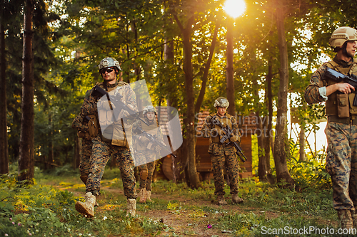 Image of Soldier fighters standing together with guns. Group portrait of US army elite members, private military company servicemen, anti terrorist squad