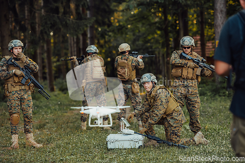 Image of Modern Warfare Soldiers Squad are Using Drone for Scouting and Surveillance During Military Operation in the Forest.