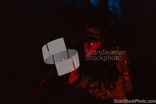 Image of Soldiers squad in action on night mission using laser sight beam lights military team concept