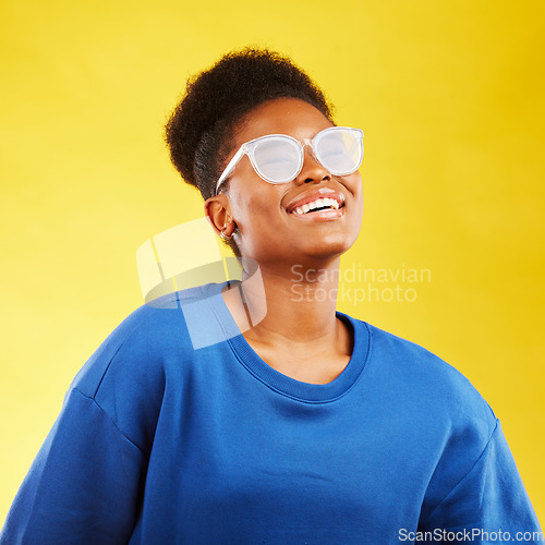 Image of Happy, smile and glasses with face of black woman in studio for vision, eye care and confidence. Gen z, fashion and happiness with female person on yellow background for health and creative style