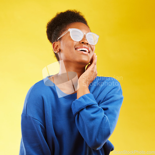 Image of Happy, laugh and glasses with face of black woman in studio for vision, eye care and trendy style. Gen z, smile and happiness with creative female person on yellow background for pride and health