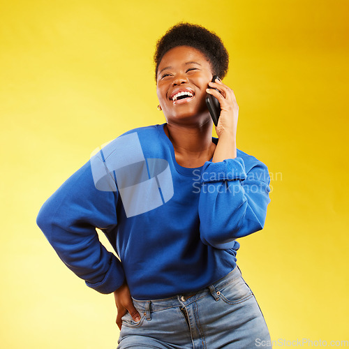 Image of Happy, phone call and black woman in studio laugh, silly or share joke on yellow background. Funny, talking and African lady with goofy, gossip or conversation on smartphone for online communication