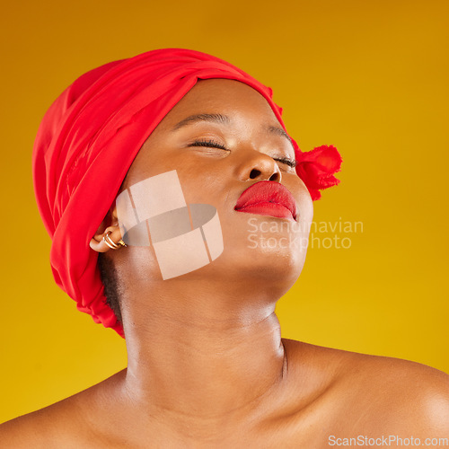 Image of Beauty, makeup and creative with face of black woman in studio for facial, red head scarf and pride. Skincare, salon and red lipstick with model on yellow background for wellness, self care and glow