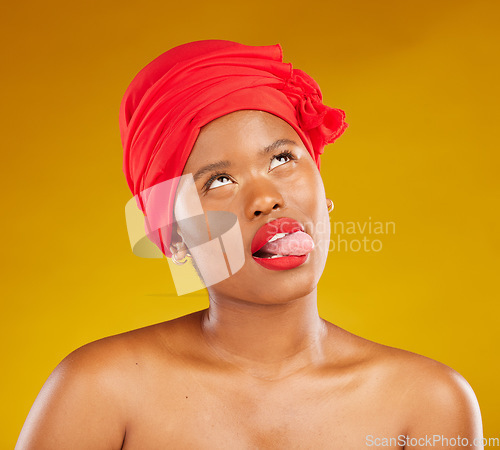 Image of Tongue, fashion and a black woman with makeup on a studio background for beauty and comedy. Idea, playful and a funny face of African girl or model with a headscarf, cosmetics and funny on a backdrop