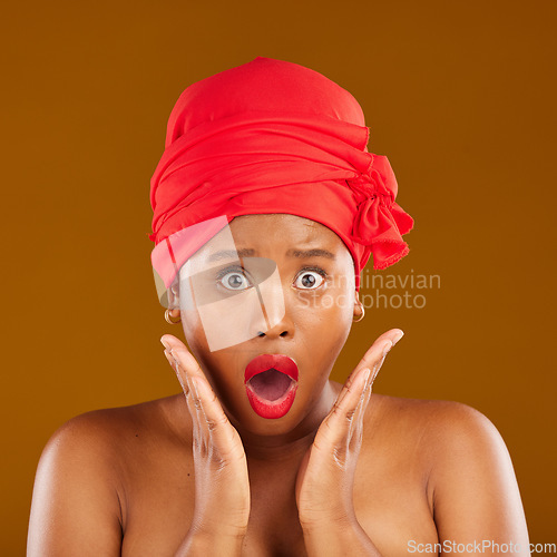 Image of Portrait, surprise and black woman with makeup, cosmetics or head wrap against a brown studio background. Face, female person or model shocked, creative and dermatology with news, self care and shine