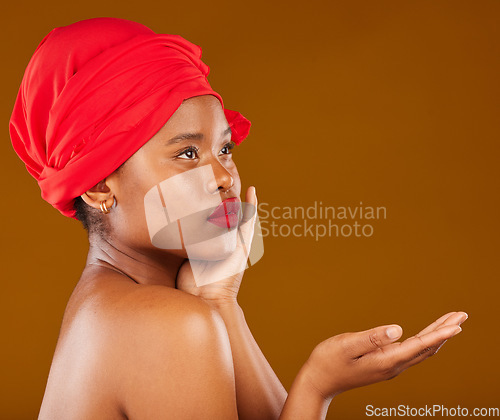 Image of Beauty, makeup and presentation with face of black woman in studio for cosmetics, creative and show. Skincare, salon and mockup with female model on brown background for wellness, self care and glow