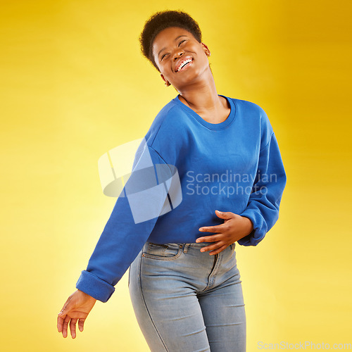 Image of Happy, laughing and a black woman in studio with fashion, confidence and a positive mindset. Playful, funny and African female model person in casual clothes on a yellow background for motivation