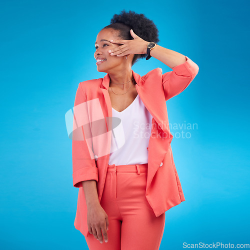 Image of Fashion, smile and confident with a black woman on blue background in studio posing in a suit for style. Runway, clothes and happy young female model standing in a trendy outfit for a magazine cover