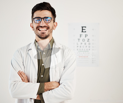 Image of Eye exam, arms crossed and portrait of man optometrist with smile, confidence and friendly service in consultation office. Ophthalmology, face and happy male eye expert proud of vision testing career