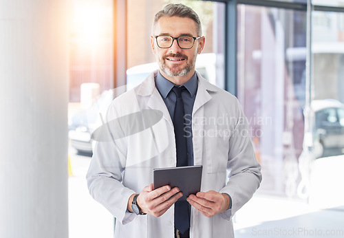 Image of Tablet, doctor and smile with portrait of man in hospital for consulting, digital and telehealth. Communication, medicine and healthcare with person in clinic for search, wellness and lens flare