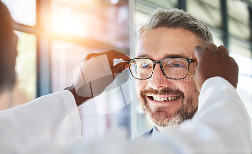 Image of Optometry, doctor and glasses for happy man at a clinic for vision, healthcare and help with eye care. Smile, retail and a male customer with an optometrist and eyewear during a medical consultation