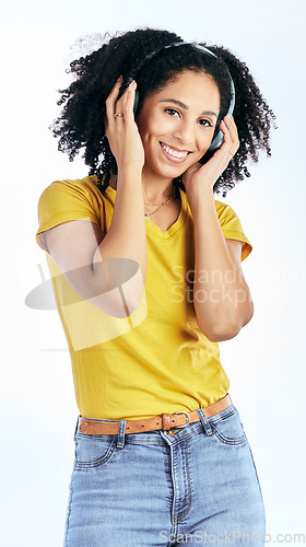 Image of Portrait, music and happy woman with headphones in studio for streaming, subscription or service on white background. Smile, face and lady listen to radio, podcast or online audio earphones playlist