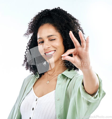 Image of Wink, studio and woman portrait with perfect hand sign for support or agree, vote or review on white background. Face, smile and emoji yes by lady with ok, approval or like, thank you or feedback