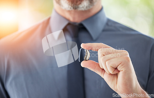 Image of Hearing aid, hands and business man with disability for communication support, listening and medical innovation. Closeup of deaf worker with audiology implant to help sound waves, amplifier or volume