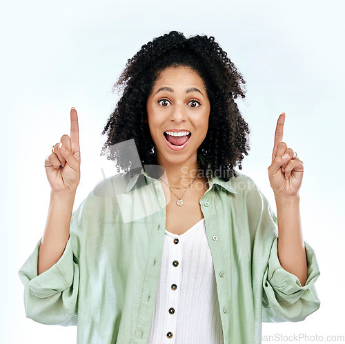 Image of Pointing up, surprise or portrait of woman excited by sale, retail offer or discount deal isolated in studio. Wow, shock or happy girl showing mockup space, news or menu promotion on white background