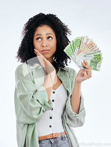 Image of Woman, money fan and thinking in studio for prize, profit or bonus from investing, savings or notes by white background. Isolated African girl, student and decision for cash, win or gambling in lotto