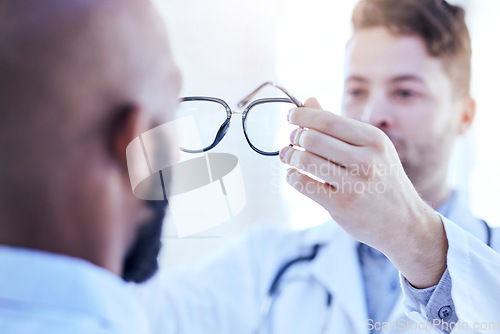 Image of Hands, man and optometrist with glasses for eye support and lens check at a doctor consultation. Medical, wellness and back of patient with vision and eyewear care with professional holding frame