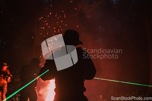 Image of Soldiers squad in action on night mission using laser sight beam lights military team concept