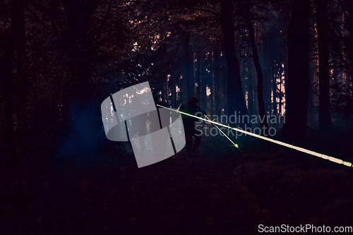 Image of Soldiers squad in action on night mission using laser sight beam lights military team concept