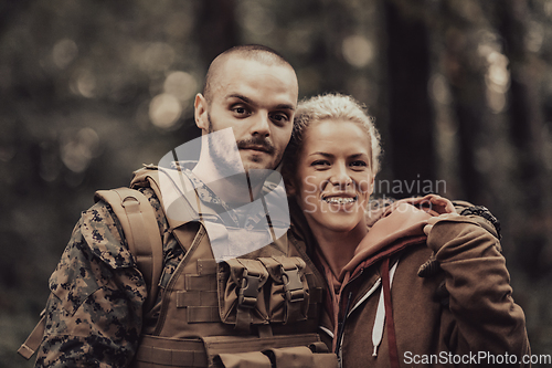 Image of Happy woman in love hugging hero soldier