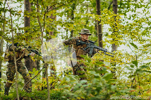 Image of A modern warfare soldier on war duty in dense and dangerous forest areas. Dangerous military rescue operations