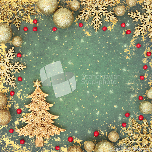 Image of Christmas Tree Holly Berry and Gold Bauble Background 