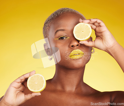 Image of Black woman, portrait and lemon for vitamin C or natural beauty against a yellow studio background. African female person with organic citrus fruit for diet, detox or facial cosmetics and makeup