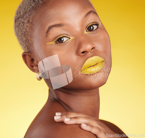 Image of Portrait, skincare and cosmetics with african girl for glow in yellow studio or background in closeup. Woman, serious and beauty face with creative art or makeup for luxury treatment with eyeliner.
