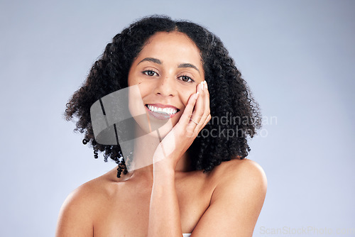 Image of Smile, skincare and portrait of woman on a studio background for beauty or natural spa. Happy, facial wellness and a young girl or model touching face for hygiene or grooming isolated on a backdrop