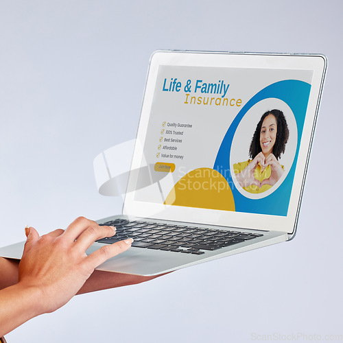 Image of Laptop, hands and insurance website with a customer in studio on gray background for life cover sign up. Computer, security or internet with a female person searching for information about protection