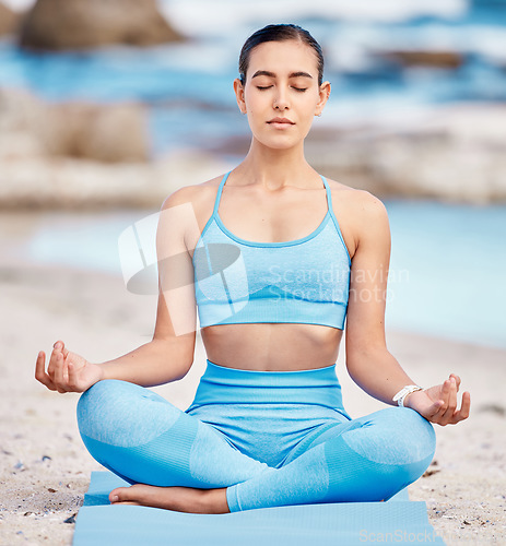 Image of Meditation, fitness and zen woman at the beach for workout or training as health, mindfulness and wellness routine. Healthy, body and person exercise to balance chakra by doing the lotus at sea