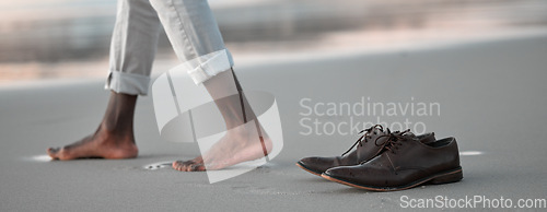 Image of Shoes, walk and beach for business man, freedom and sunset to relax in nature by water after work. Person, ground and ocean with barefoot adventure for vacation, outdoor and steps on sand at dusk