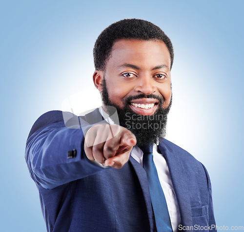 Image of Portrait, business and black man hand pointing in studio for hiring, recruitment or opportunity on blue background. Face, smile and African male person with you, emoji and coming soon or contact us