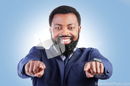 Image of Business, portrait and black man hand pointing in studio for hiring, recruitment or opportunity on blue background. Face, smile and African male person show you, emoji and coming soon or contact us