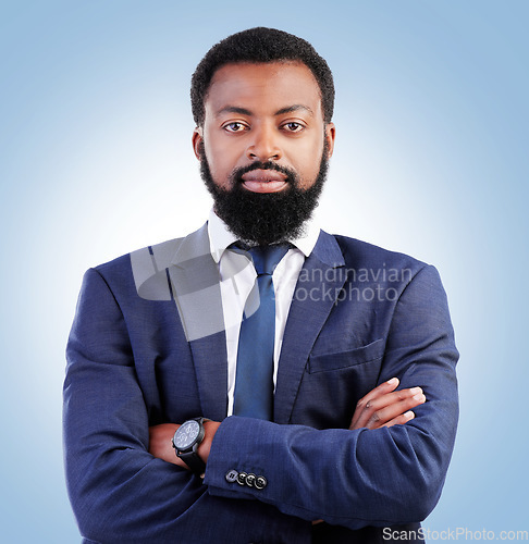 Image of Serious, crossed arms and portrait of businessman in a studio with success, confidence and leadership. Pride, professional and headshot of a young, male and African lawyer isolated by blue background