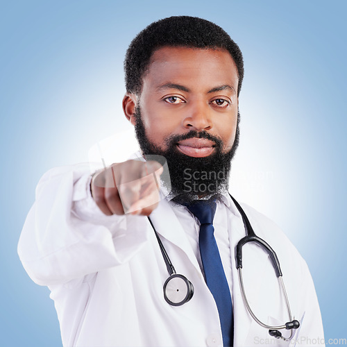 Image of Black man, portrait and doctor pointing to you for healthcare selection against a blue studio background. Face of African male person or medical professional in decision or choice for clinic checkup