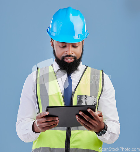 Image of Black man, architect and tablet for construction inspection or planning against a blue studio background. African male person, engineer or contractor working on technology for industrial architecture