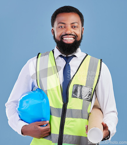 Image of Happy black man, portrait and architect with blueprint for construction against a blue studio background. African male person, engineer or contractor smile with hard hat or documents for project plan