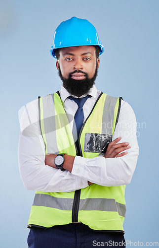 Image of Engineering, man or serious portrait with arms crossed in studio in development, building construction or industrial technician. Black male architect, contractor or project manager on blue background
