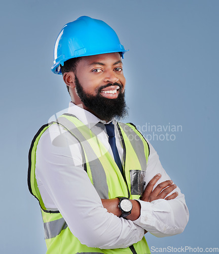 Image of Construction, black man and portrait with arms crossed in studio for building inspection, engineering or industrial development. Happy male architect, contractor or project manager on blue background