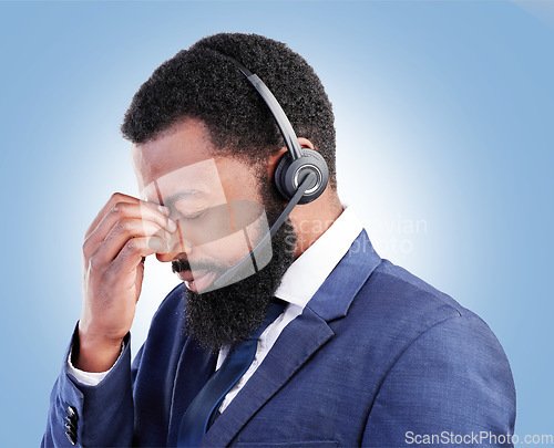 Image of Customer service face, studio black man and depressed over tech support fail, insurance agent crisis or call center burnout. Mental health risk, e commerce or African person crying on blue background